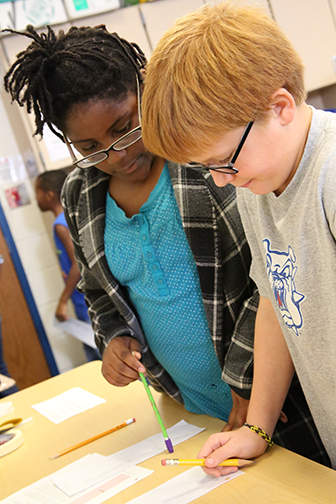 Photo of two students participating in a STEM related activity
