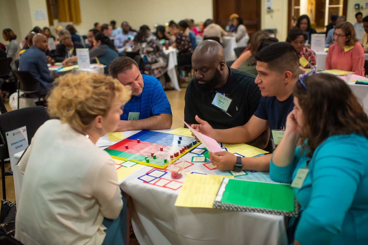 Photo Credit: IMG Artistry. Participants engage in the "Change Game" simulation.