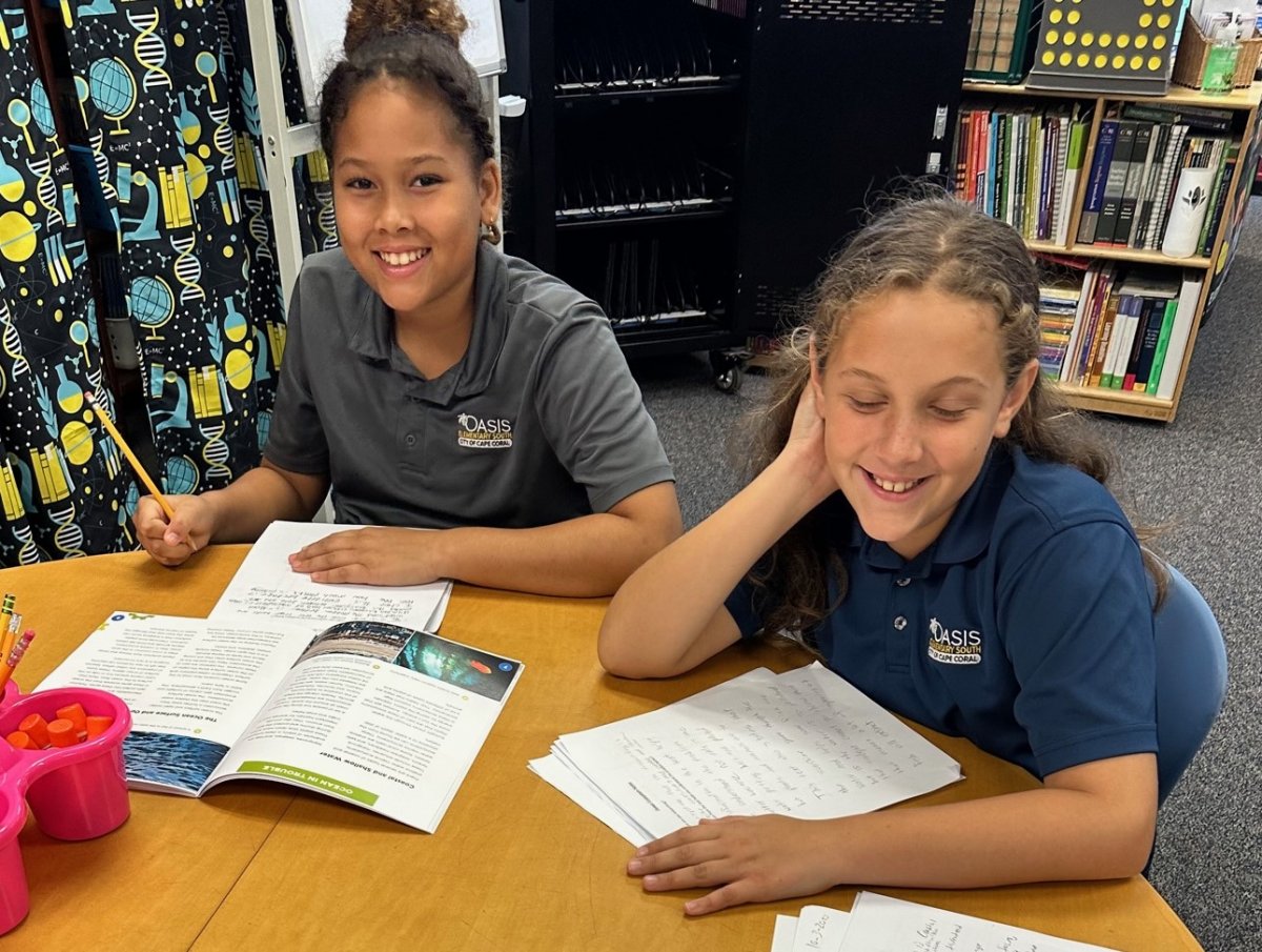 two fifth grade students taking notes about a reading called “Ocean in Trouble”