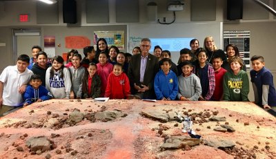 A group of students around s model of the Martian surface.