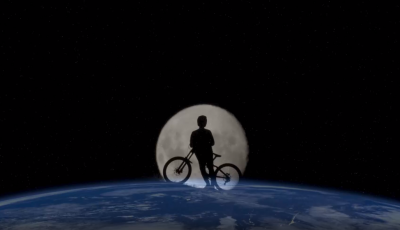 Image of the earth from space with the moon behind it and peaking out above Earth with a silhouette of a child and a bike in the image of the Moon.