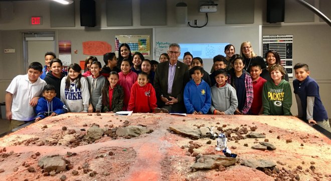 A group of students around s model of the Martian surface.